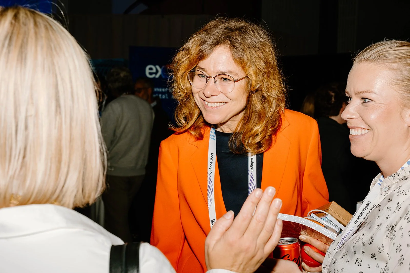 3 female corporate leaders engaging in a conversation 
