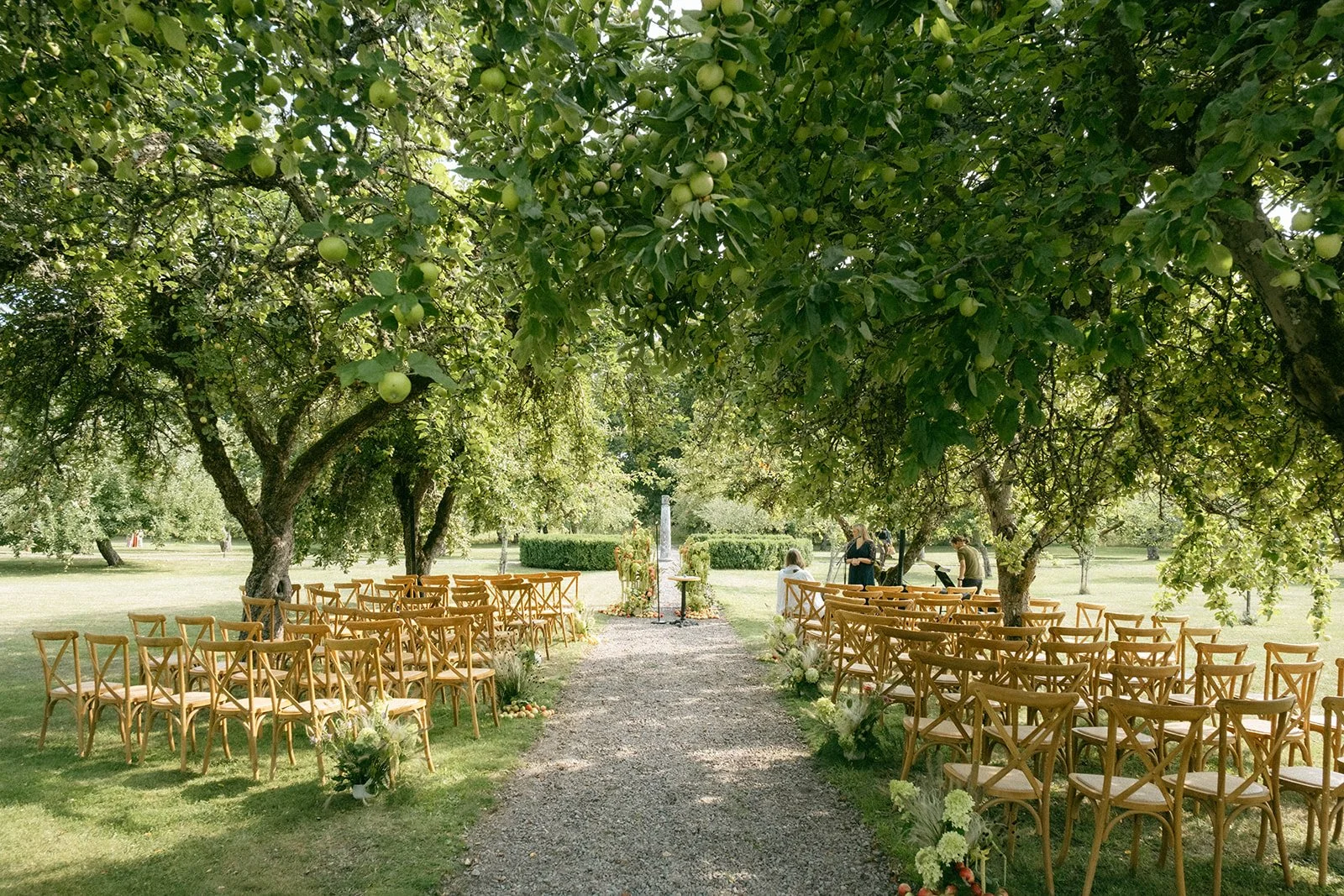 Wedding ceremony beneath the apple trees at Krusenberg Herrgård near Uppsala, Sweden.