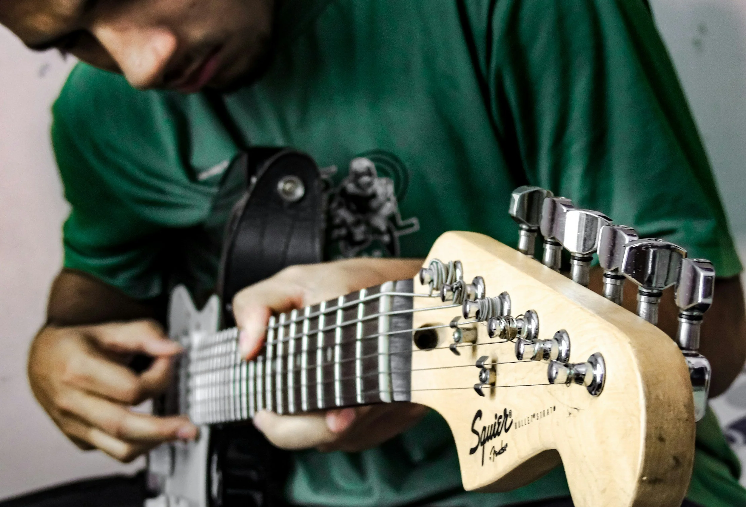 Guitar player holds his electric guitar that recently received a basic professional set up, and pickup replacement in Fleet, Hampshire.
