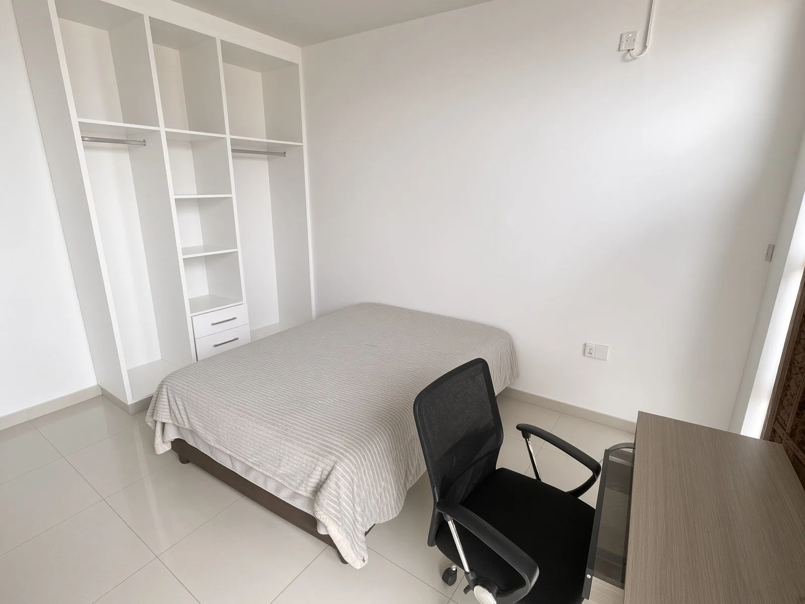 Bedroom with built-in closet, work desk and office chair in a house for sale in Gaborone