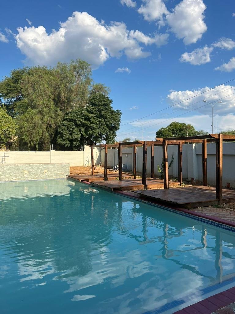 Communal swimming pool and wooden pergola deck in a secure apartment complex, Extension 11 Gaborone
