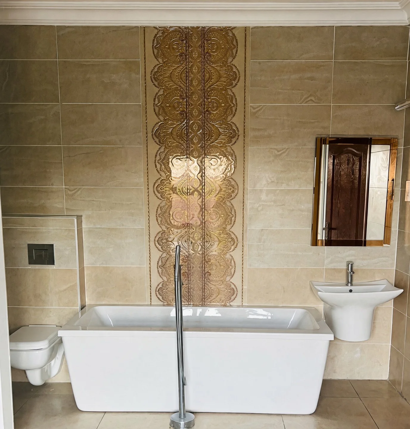 Ensuite bathroom with freestanding bath, decorative feature tiles and wall-hung toilet, apartment for rent Extension 11 Gaborone