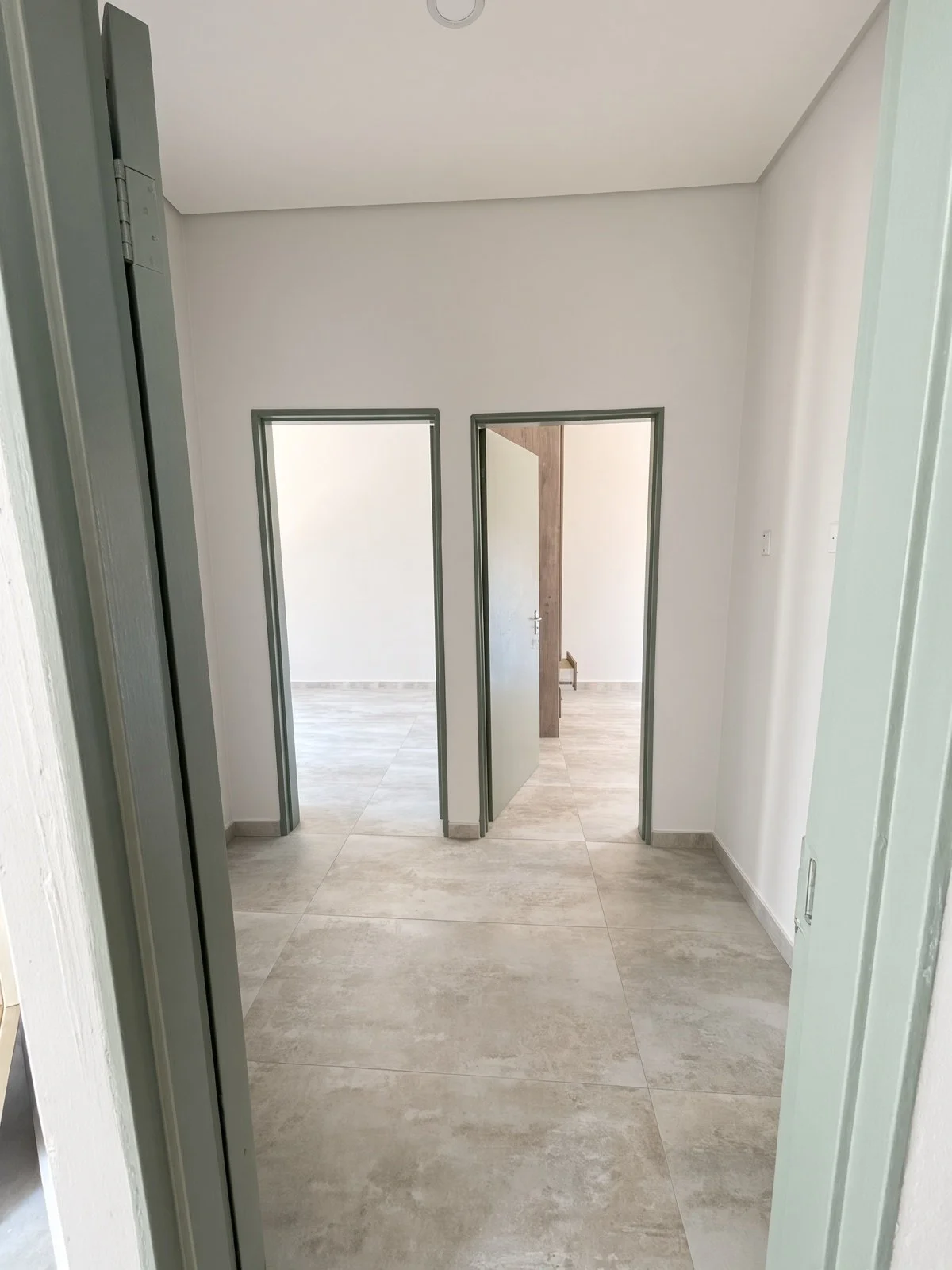 Open doorways into tiled rooms in a 2-bedroom house for rent in Maruapula