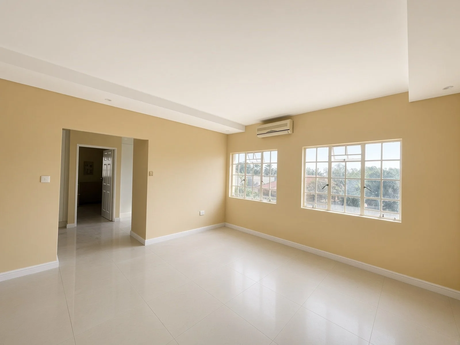 Spacious tiled lounge opening onto a balcony in a 5-bedroom house for rent in Block 9 Gaborone