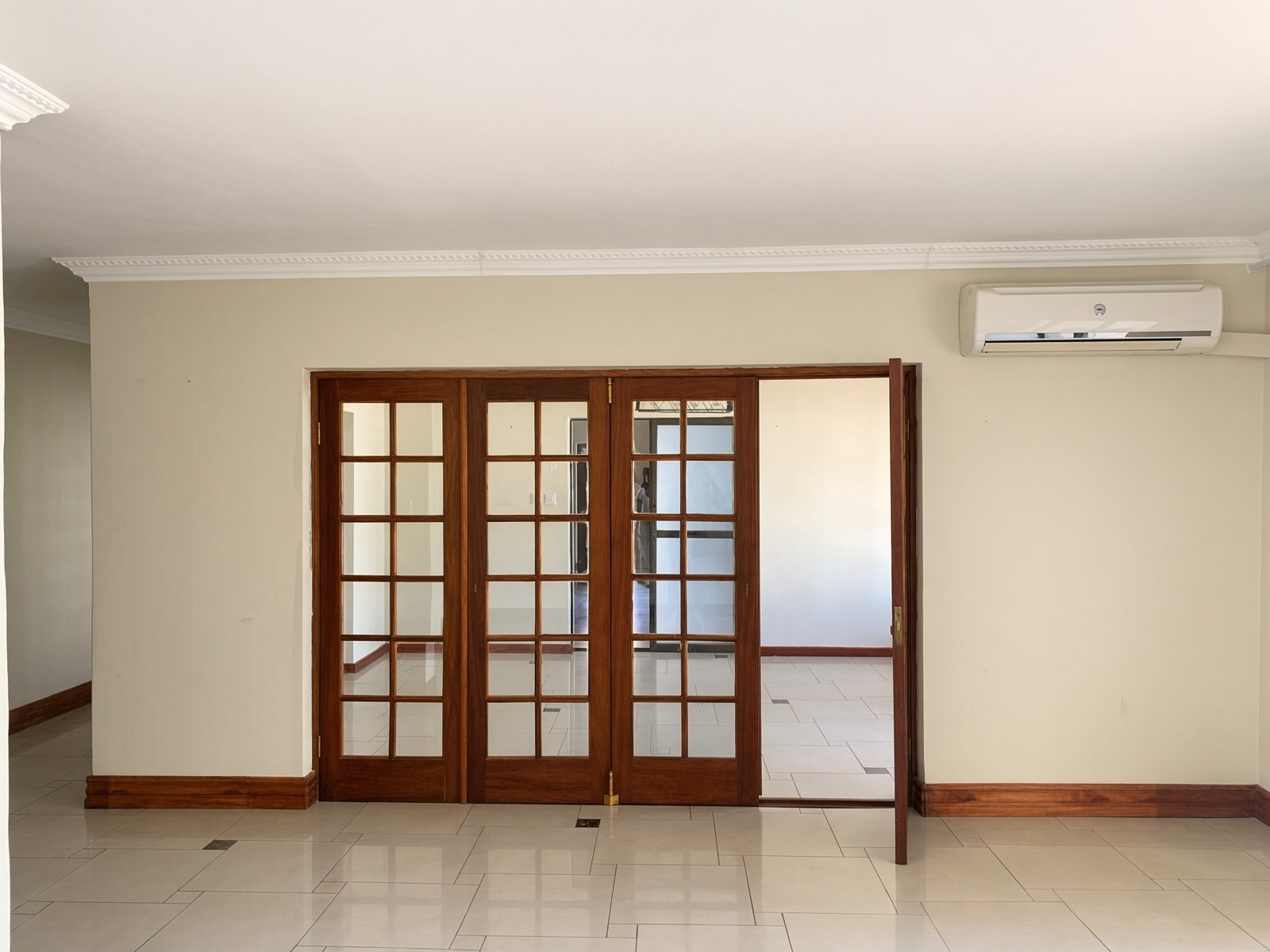 Wooden French doors between living areas in a 4-bedroom house for rent in Phakalane