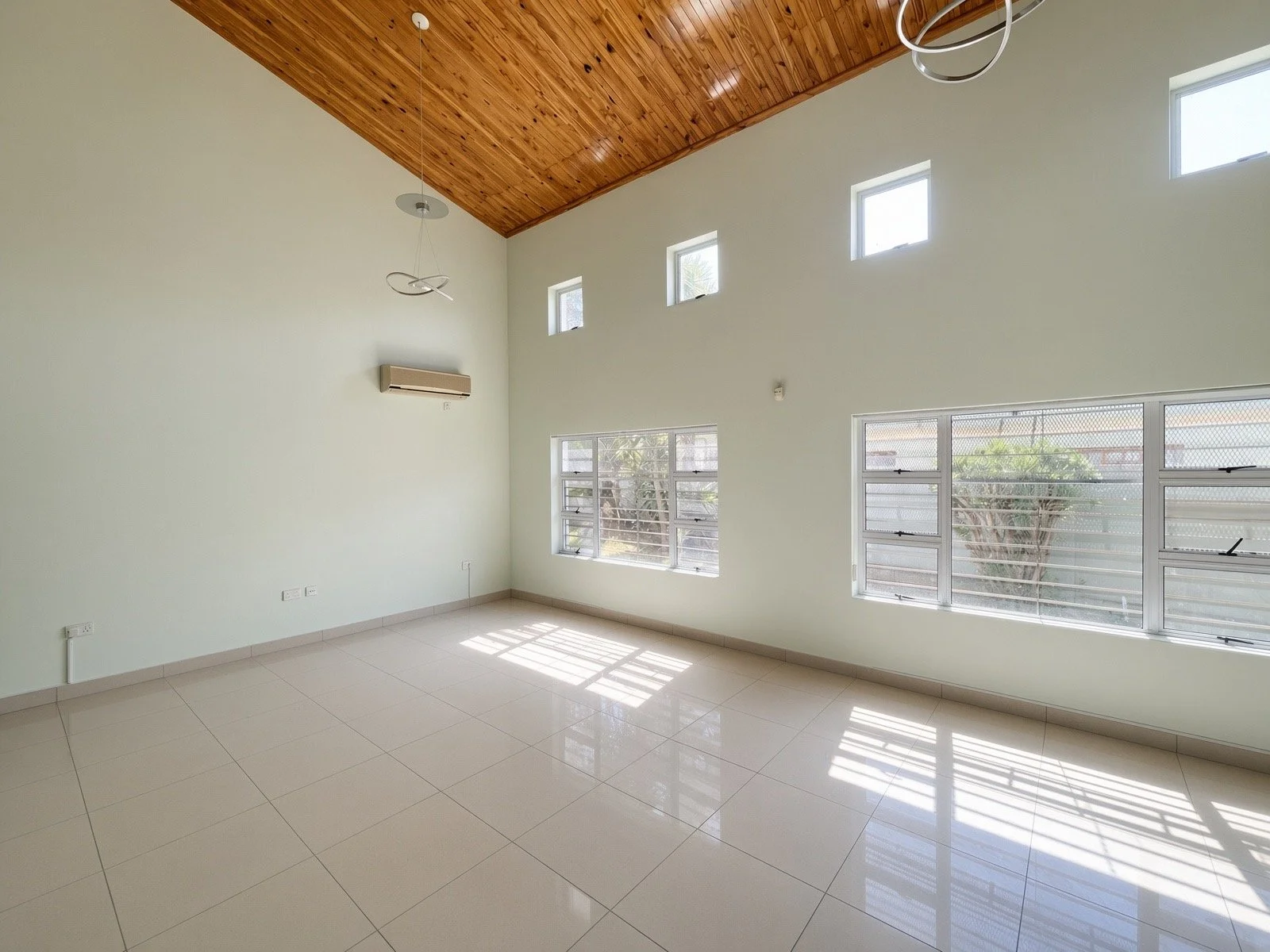 Air-conditioned gym room or flexible upstairs lounge with tiled floor in the 4-bedroom rental home, gated estate Phakalane. Nestgeeks.