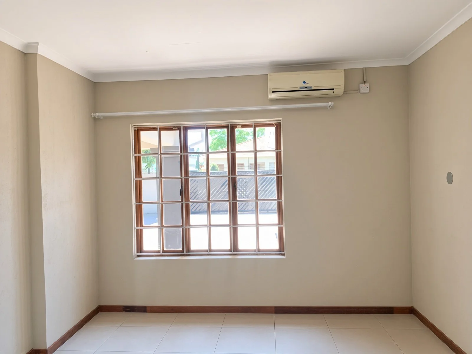 Office or study with barred window and air conditioning in a 4-bedroom house for rent in Phakalane