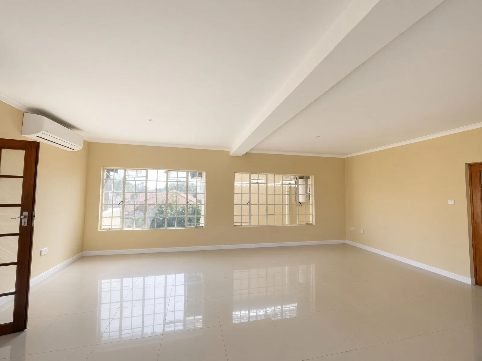 Bedroom with air conditioning, window and fitted wardrobe in a family house for rent in Block 9 Gaborone