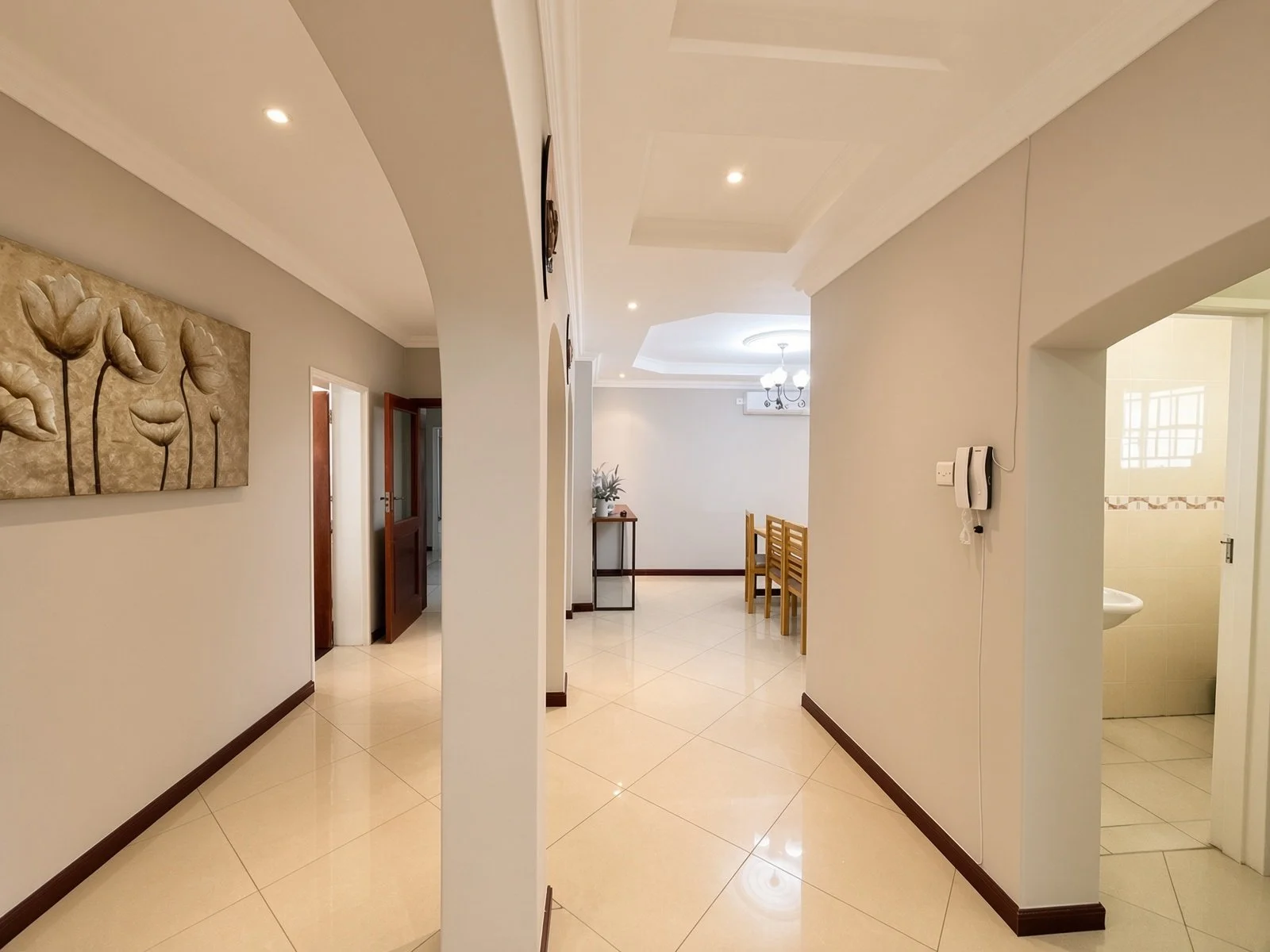 Hallway with arches leading to the dining area and guest facilities in the fully furnished 5-bedroom rental house, Phakalane. Nestgeeks.