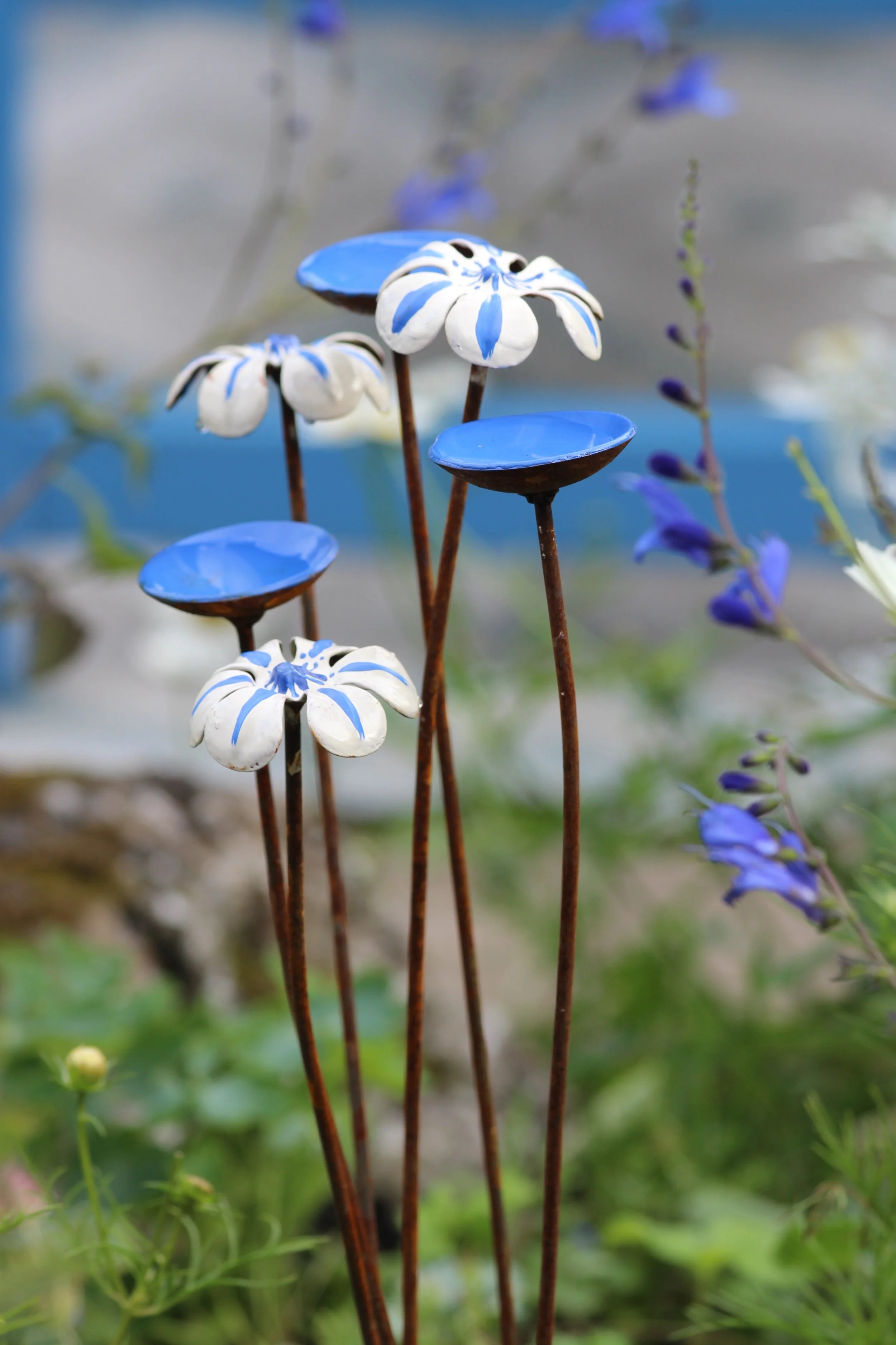 Wildlife garden gift featuring a blue and white bee waterer and butterfly watering station, handmade in Wales