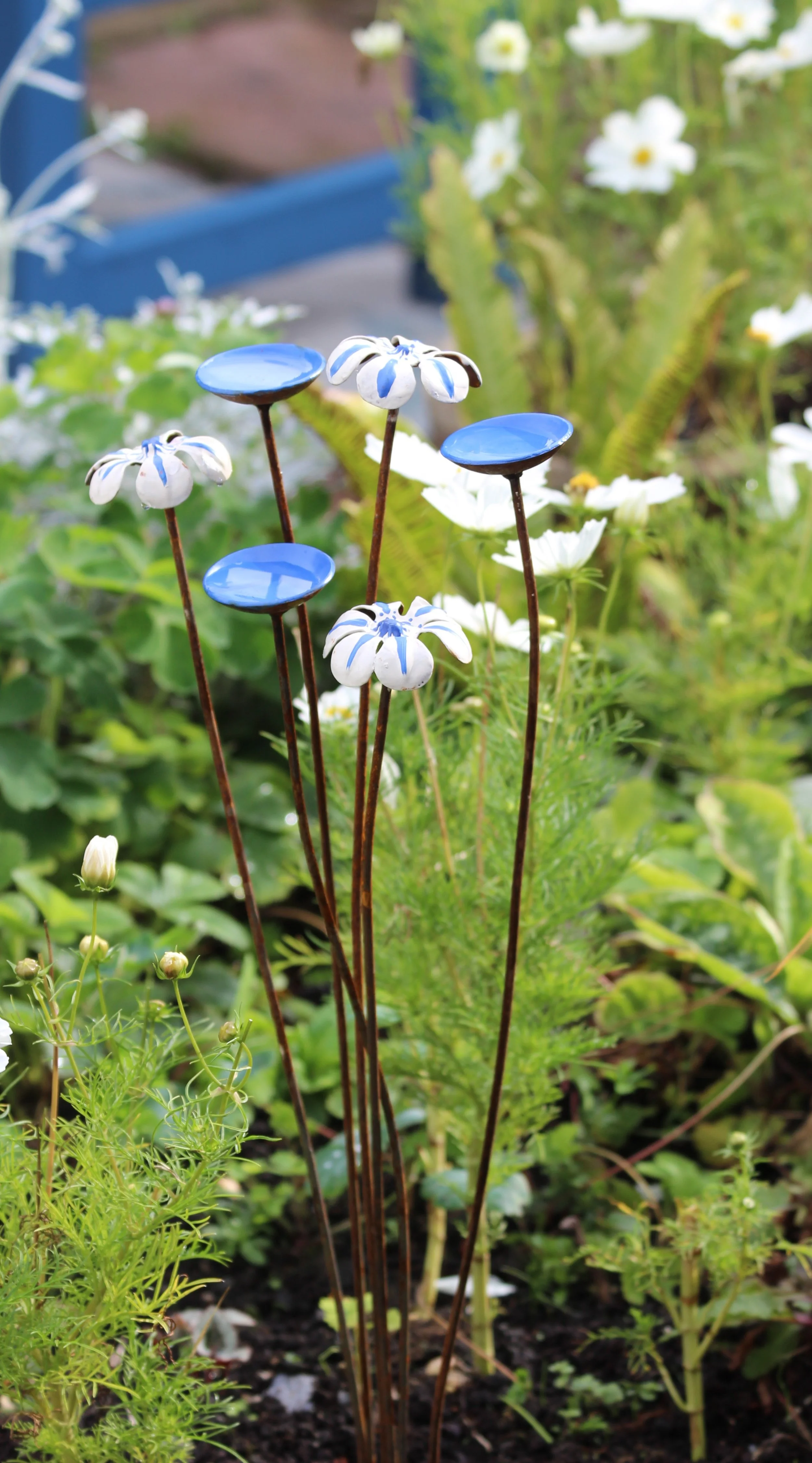 Blue and white wildlife garden ornament with bee and butterfly water dishes, handmade steel garden sculpture by Tessa Hayward
