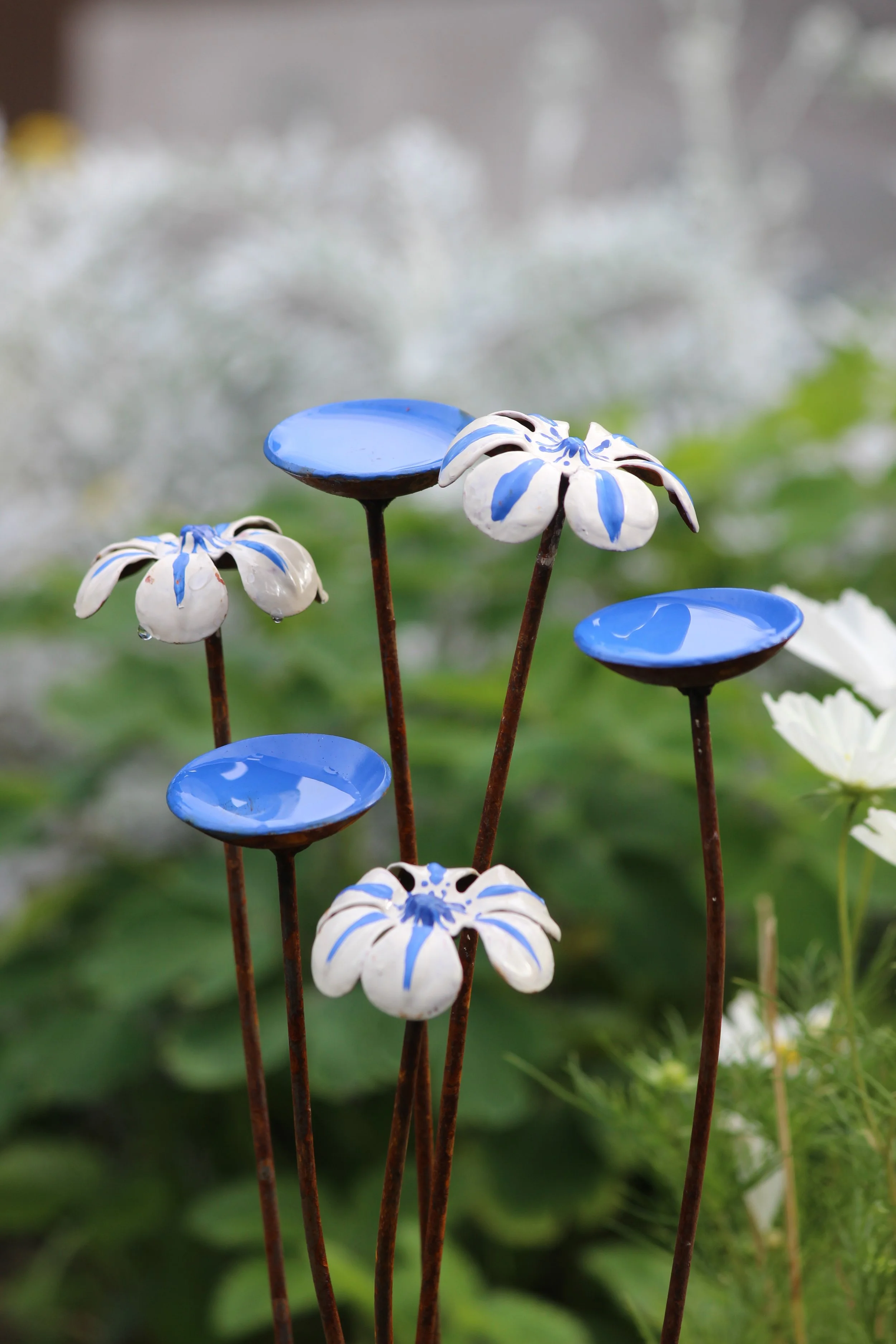 Blue and white handmade bee waterer and butterfly water station garden sculpture with rusted steel flowers