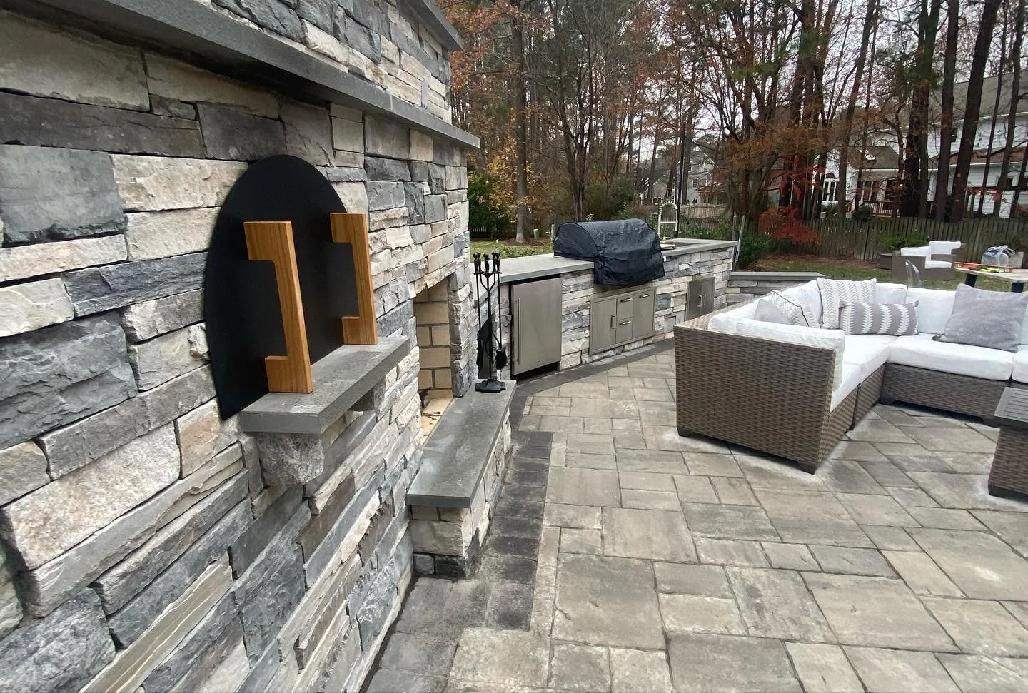 Outdoor patio with outdoor kitchen and fireplace
