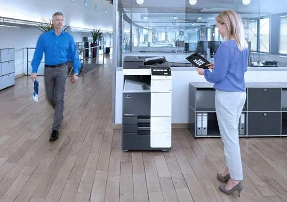 modern office with a rental printer and people printing