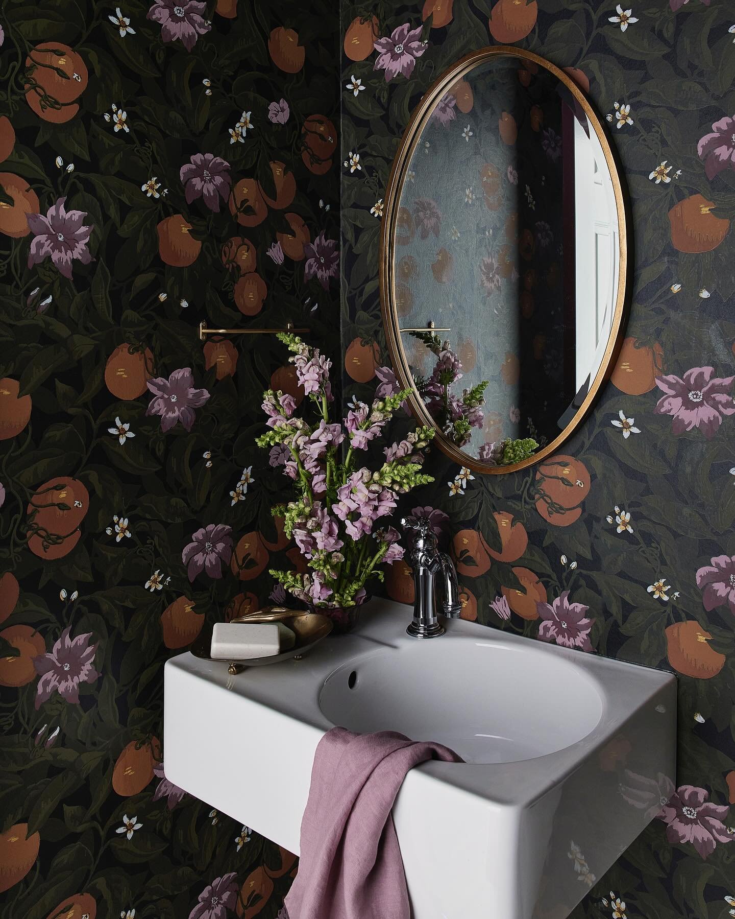 You don&rsquo;t always need to change everything.  This powder room had a tiny European sink that totally worked once we made a few tweaks.  We added some amazing wallpaper, swapped out the smaller plumbing fixtures, cleaned up the tile and now she l