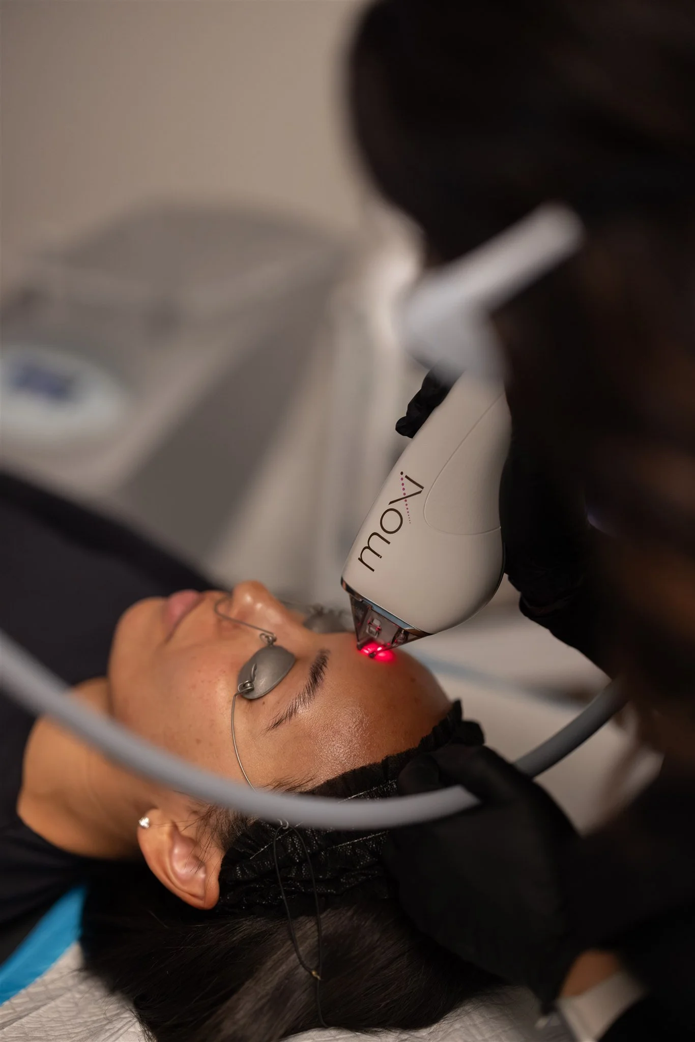 Aesthetic nurse practitioner performing a laser treatment on patient at Trouvé Medspa in Northeast Ohio