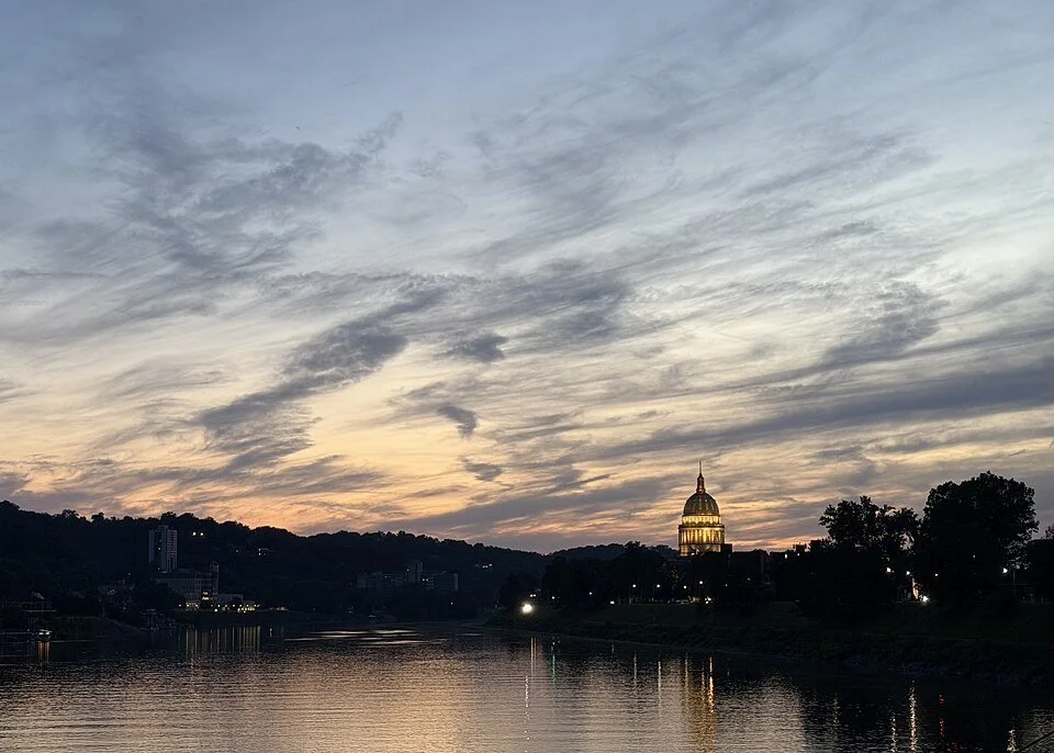 West Virginia State Capitol dome and Kanawha River at sunset in Charleston