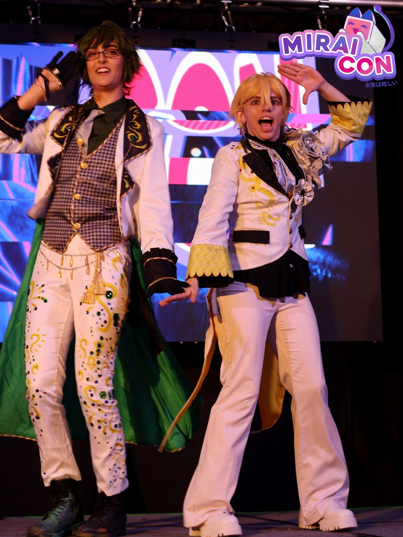 A promotional image for MiraiCon with three people in colorful costumes on stage, with a dark background and small lights. Overlaid text says 'Idolfest Applications Apply by July 18!'.