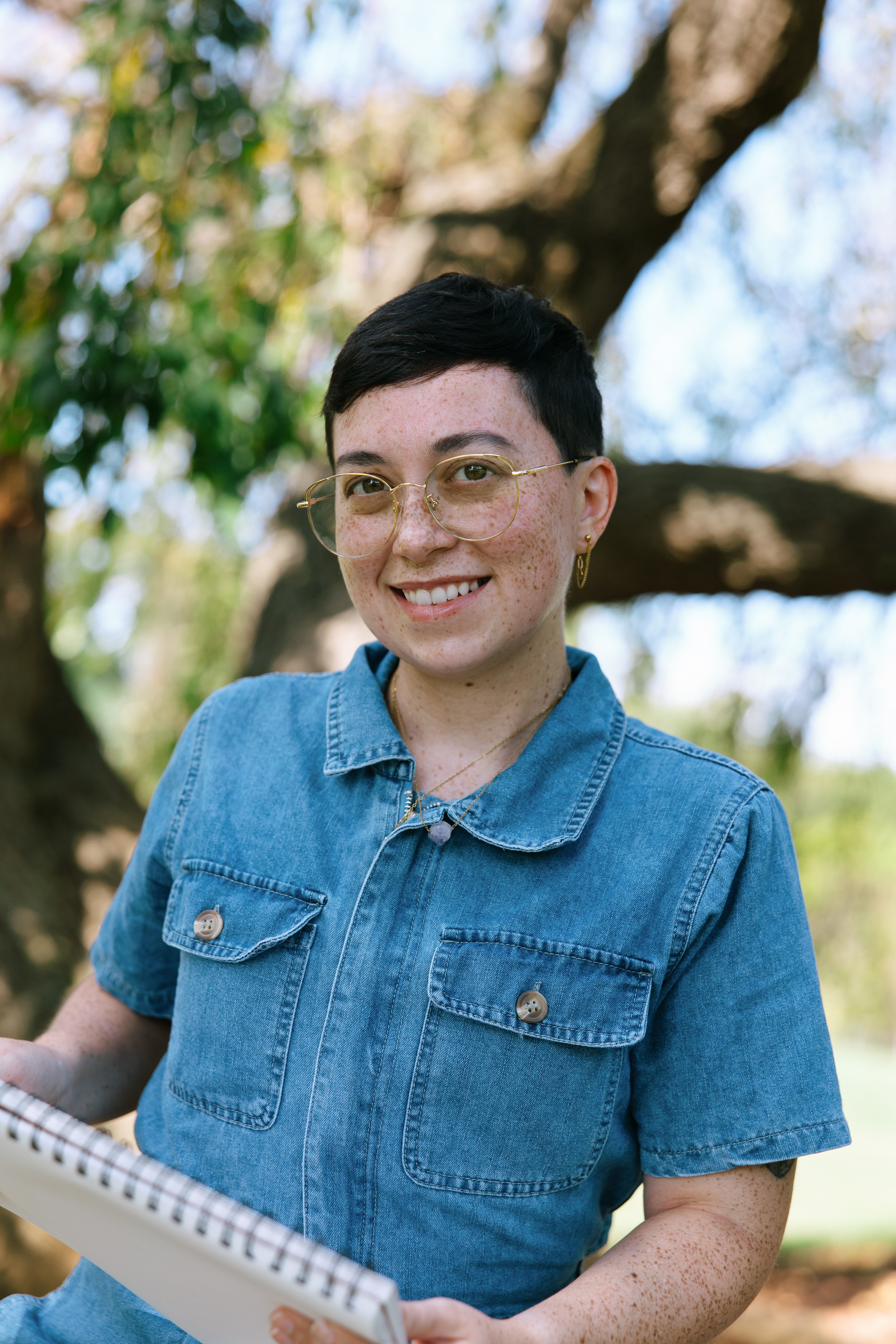 Maryland Art Therapist Kristy Leone at Labyrinth Art and Wellness holding art supplies before a virtual telehealth session for adults with OCD.