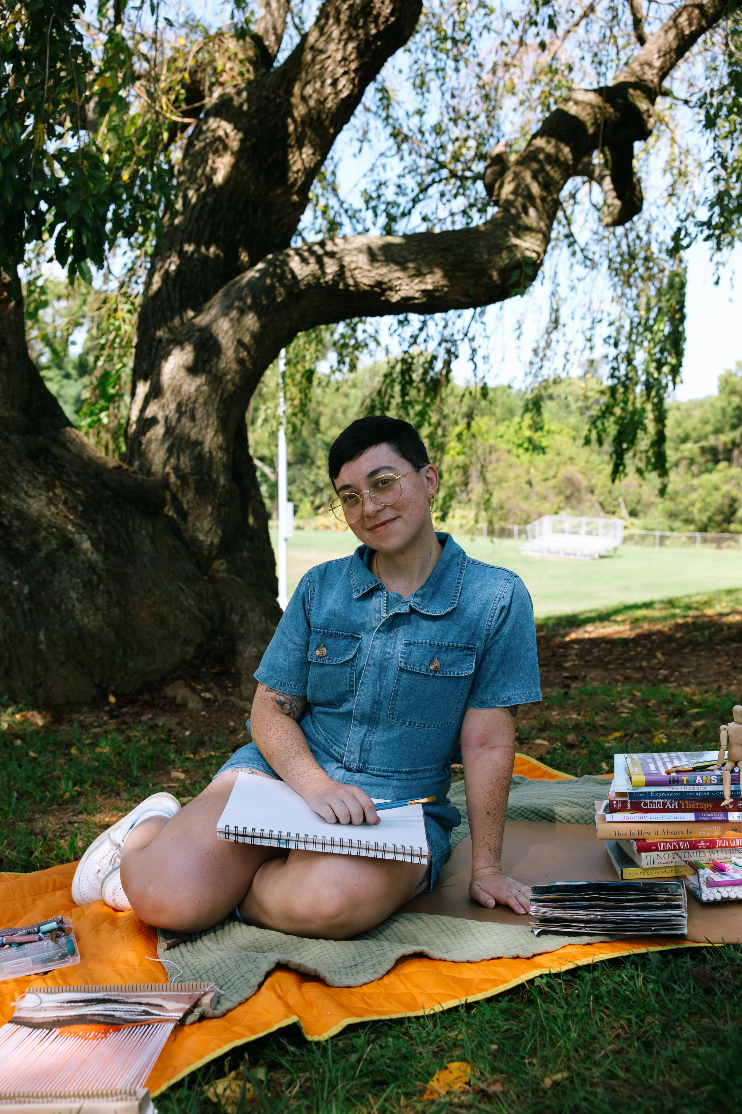 Maryland art therapist and artist Kristy Leone at Labyrinth Art and Wellness is a licensed art therapist that provides art therapy sessions in person in Baltimore County. Kristy is featured with markers and drawing materials.