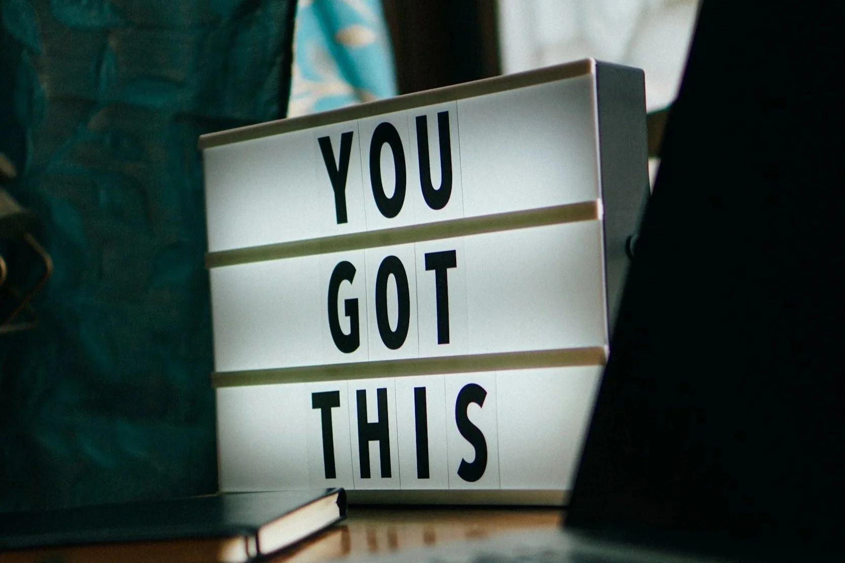 Lightbox sign on a desk displaying the words You got this, symbolising motivation and mental focus in training and racing.