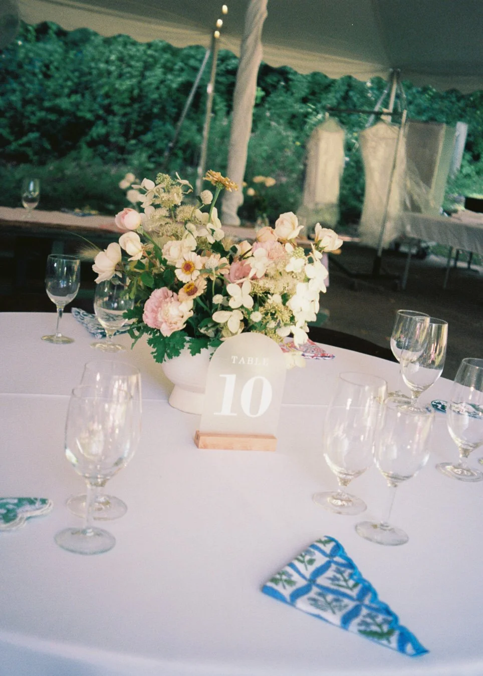 outdoor wedding reception blue and green and pink flowers