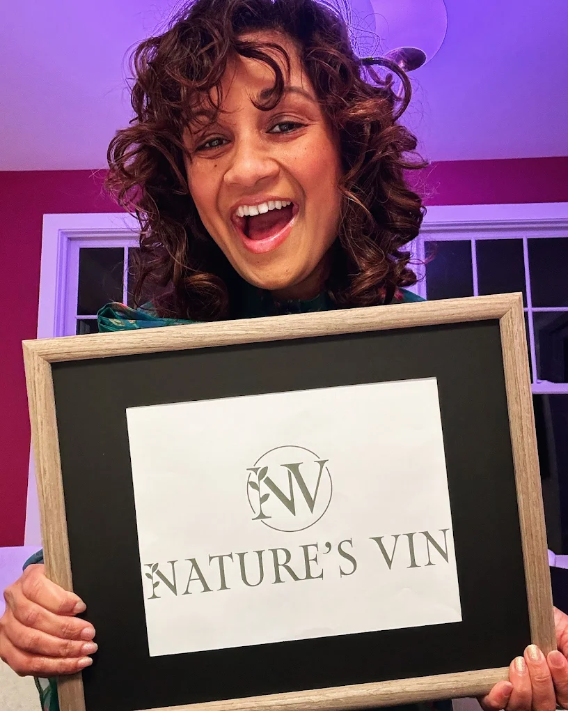 Ragini parmar holding a framed photo of the natures vin branding