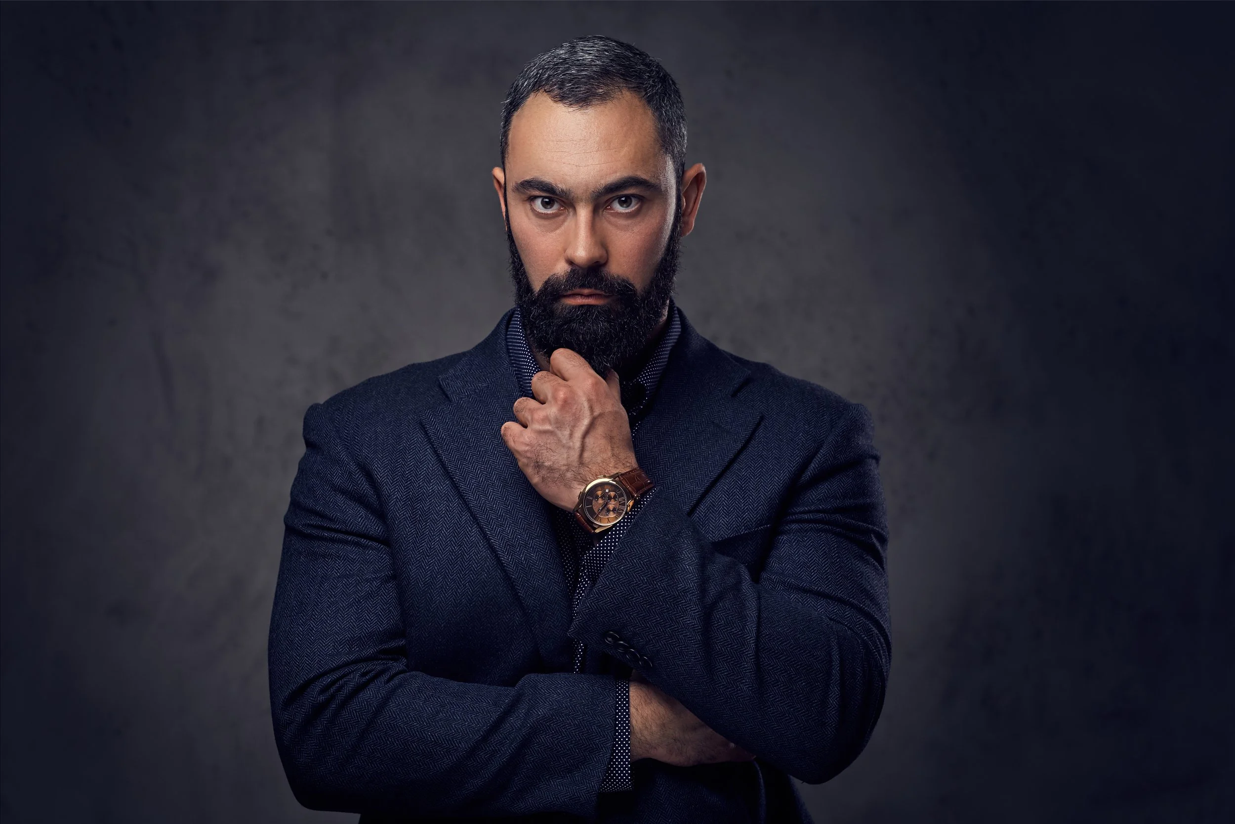 studio-portrait-serious-bearded-male-dressed-suit.jpg
