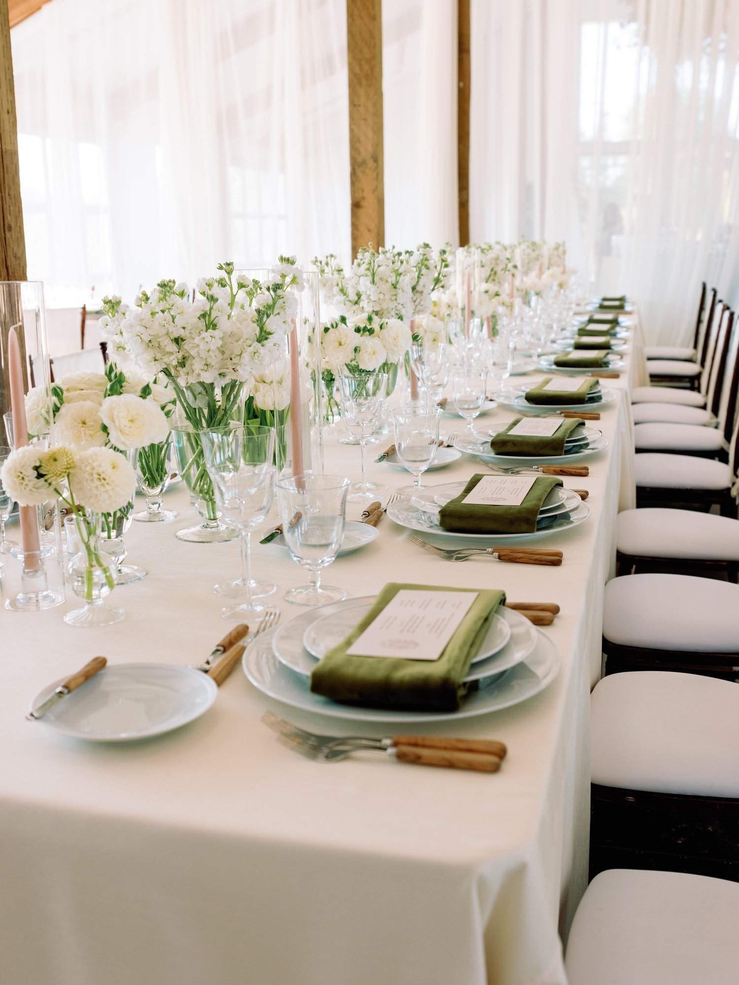 white-table-floral-arrangements-indoor-wedding-dinner.jpg