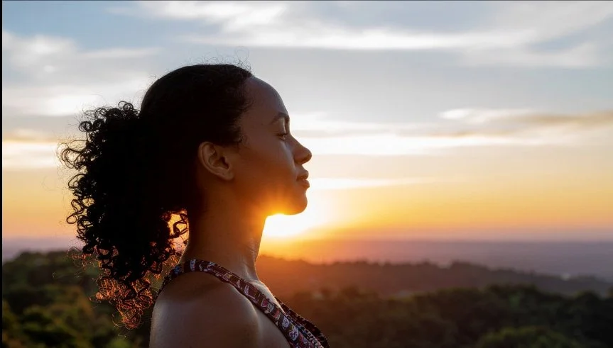 Woman standing calmly outdoors at sunset representing healing from childhood trauma through EMDR therapy
