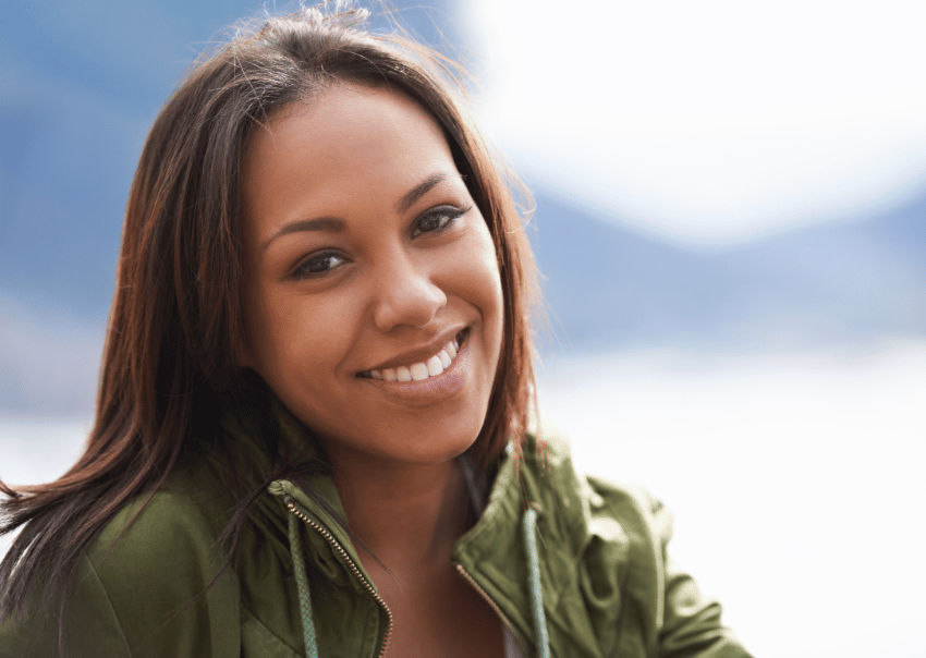 Person with a relaxed expression and soft eye contact, representing feeling more calm, connected, and present after working through childhood trauma in therapy