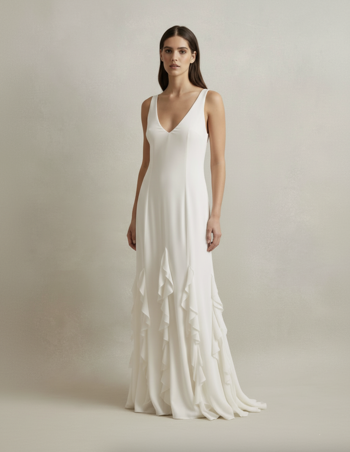 A statement for the big day. The Gia Dress features a dramatic ruffled skirt paired with a deep V neckline, striking the perfect balance between romance and boldness for a truly unforgettable entrance.