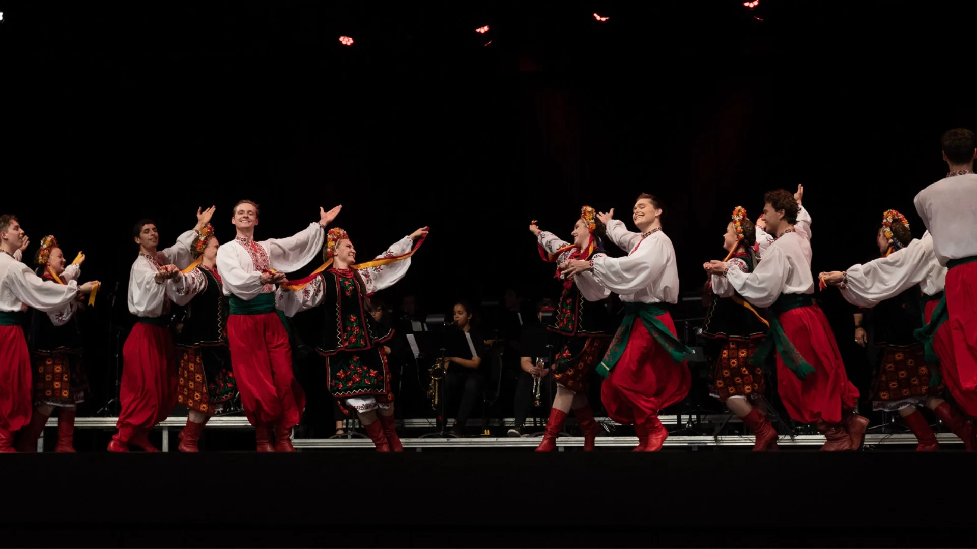 Rusalka Ukrainian Dance Ensemble performing vibrant traditional Ukrainian choreography on stage in Winnipeg, dressed in embroidered costumes and red boots