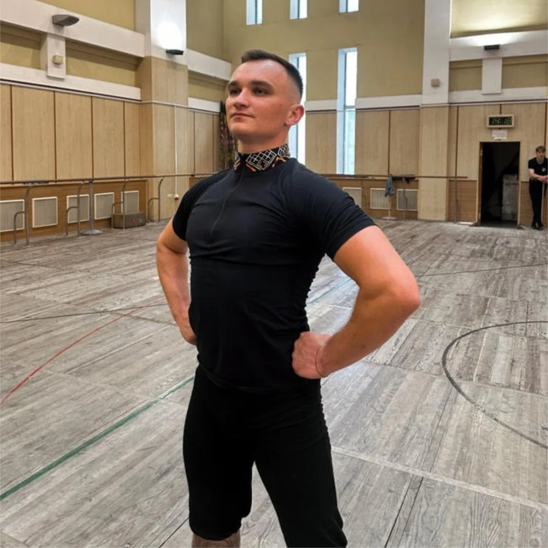 Ukrainian dance instructor Dmytro standing in a rehearsal hall, leading youth development at Rusalka’s Ukrainian Dance Camp in Winnipeg