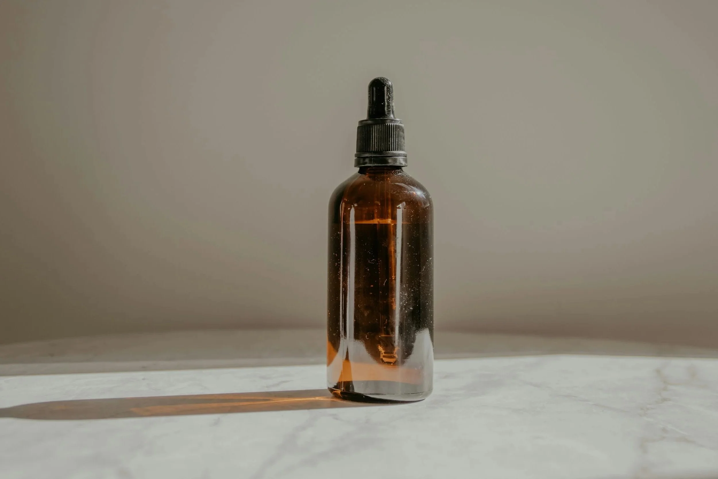 a single amber bottle with a dropper lid