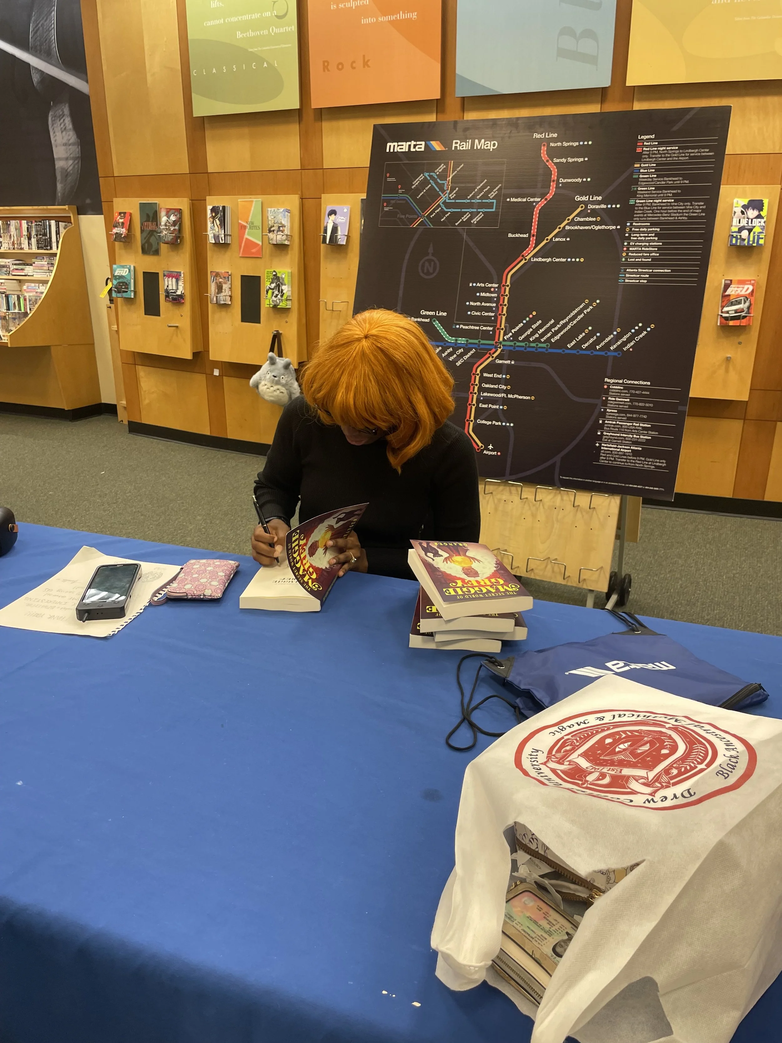 Photograph of Granger author of "The Secret World of Maggie Grey" at book signing.