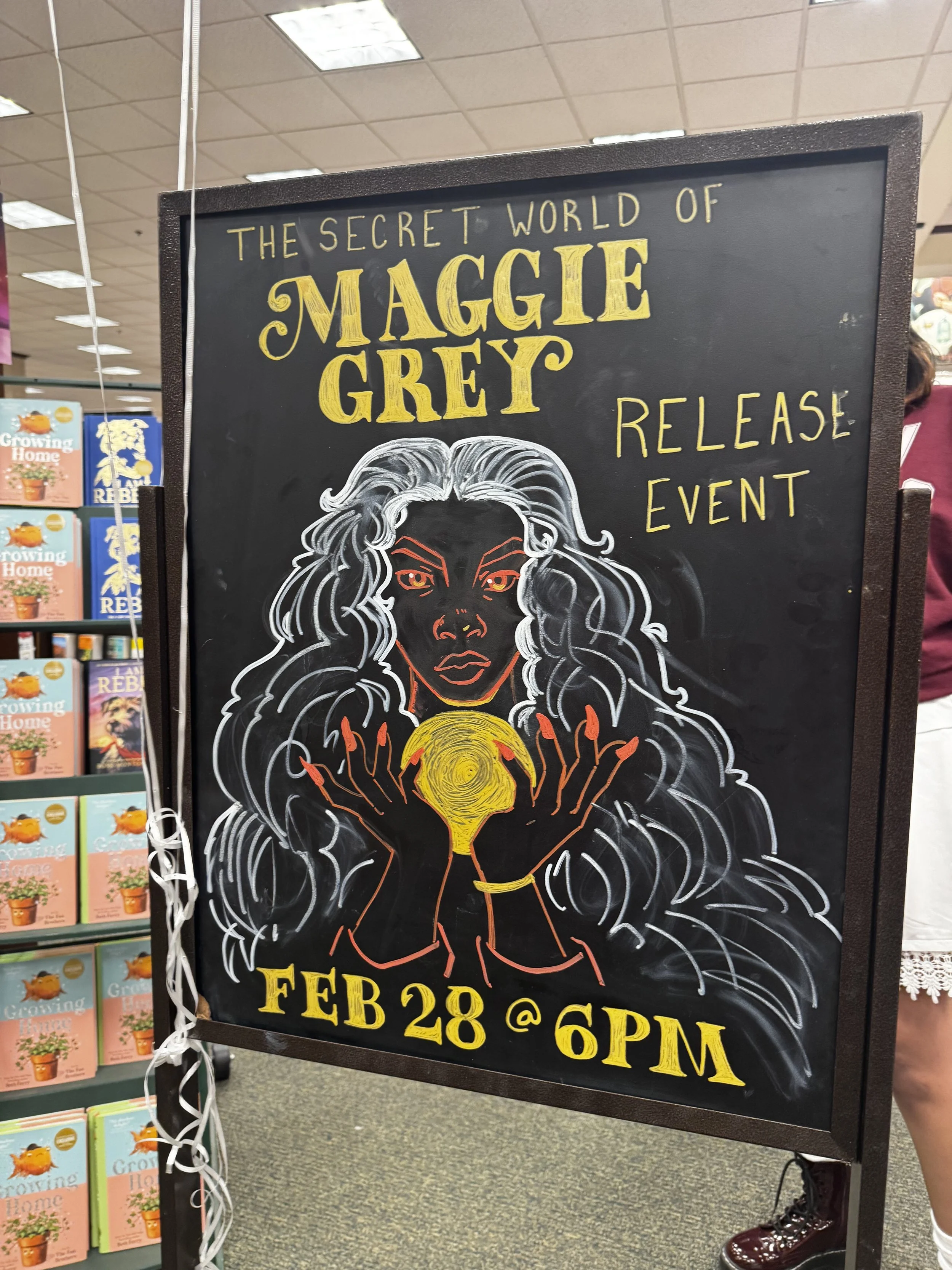 Afromuse Arts photograph of event sign at "The Secret World of Maggie Grey" book signing.