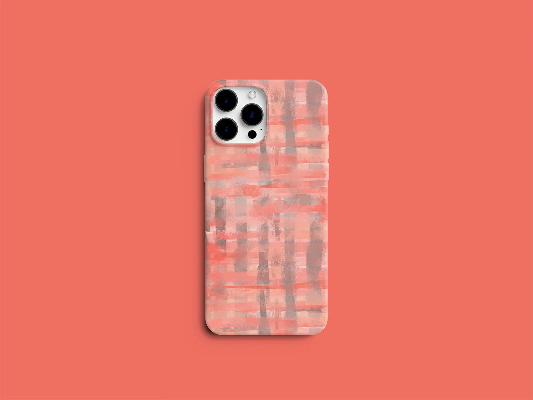 Smartphone with a pink, peach, and gray patterned case on a coral background.