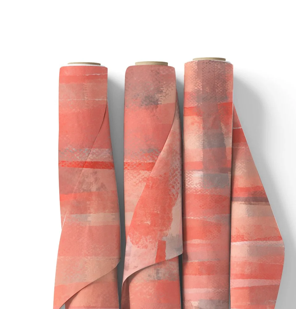 Four rolls of pink wrapping paper with abstract patterns, partially unrolled, placed against a white background.