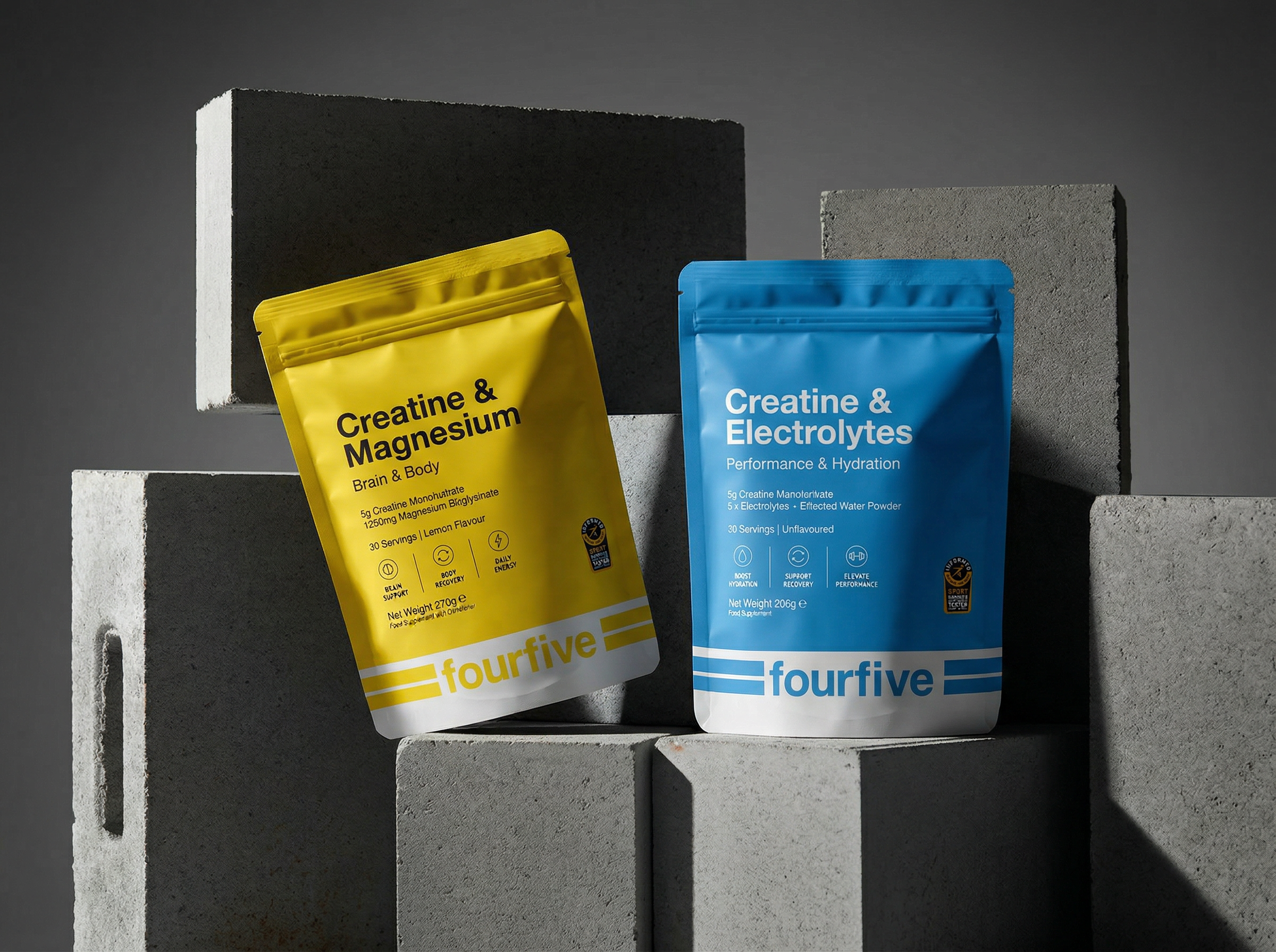 freepik_photorealistic-studio-product-shot-of-two-standup-supplement-pouches-placed-on-stacked-concrete-blocks.-img2-pouch-1-hero-img5-bright-matte-yellow-creatine-magnesium-pouch-slightly-tilted_0001.png