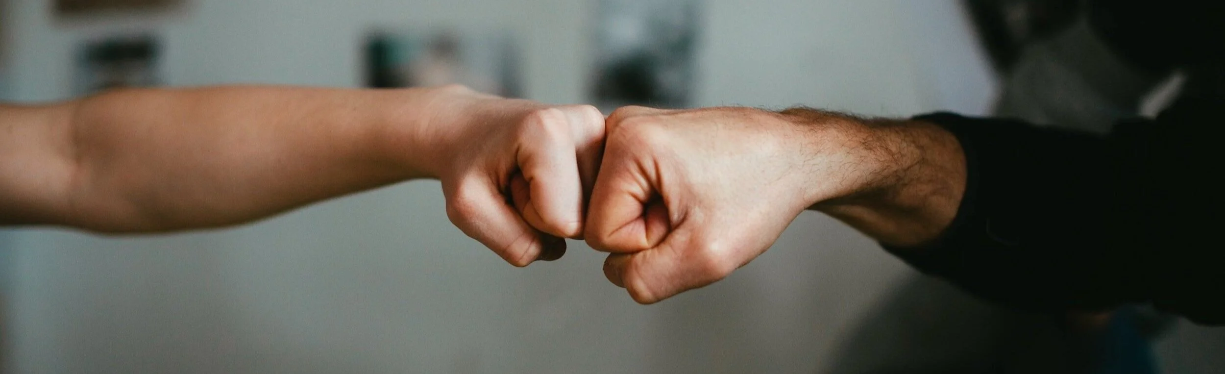 Two fists bumping each other in a friendly gesture.
