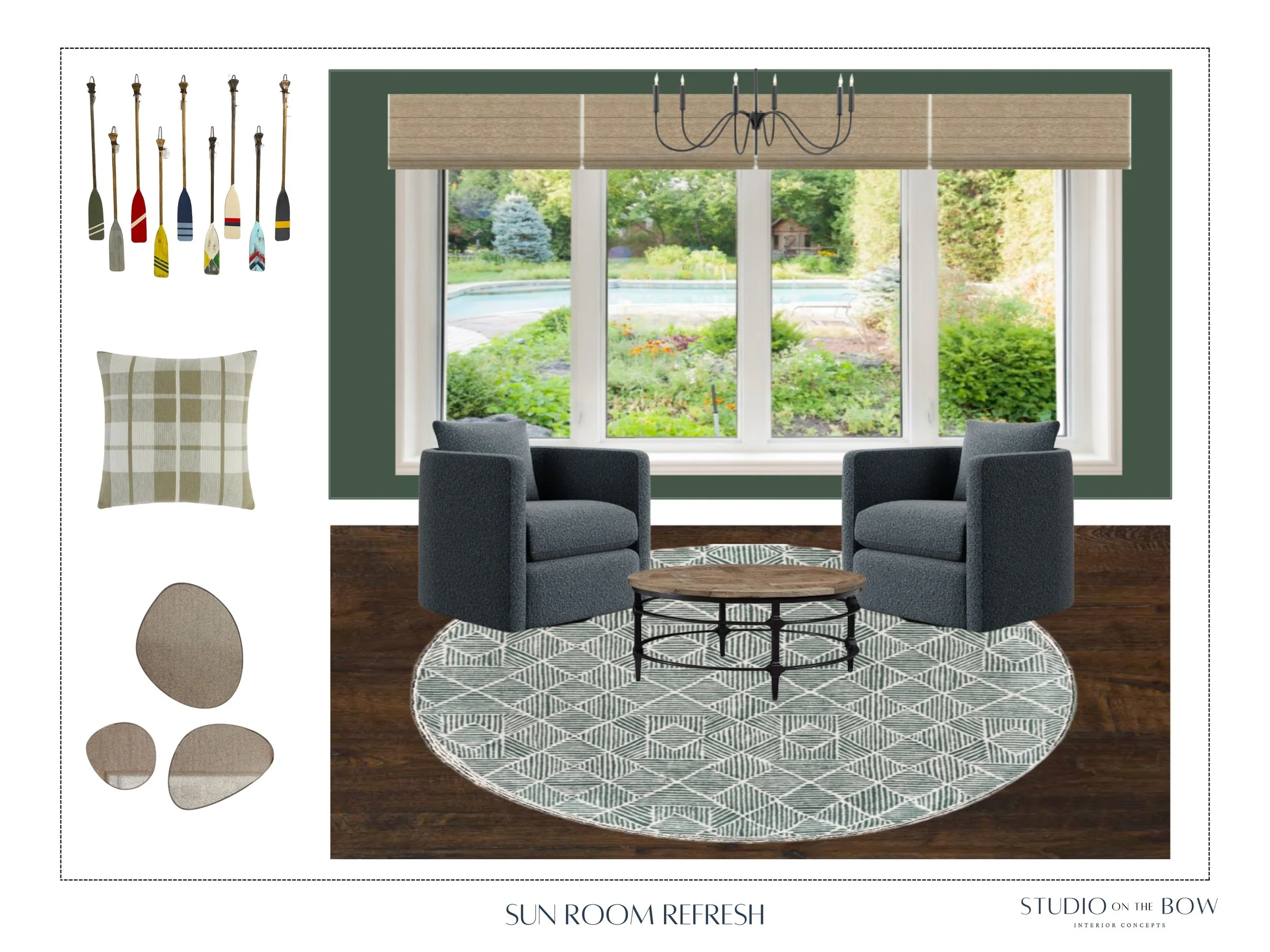 A bright sunroom with a large window overlooking a garden, featuring two dark gray armchairs, a round patterned rug, a wooden coffee table, a chandelier, and decorative paddle-shaped wall art.