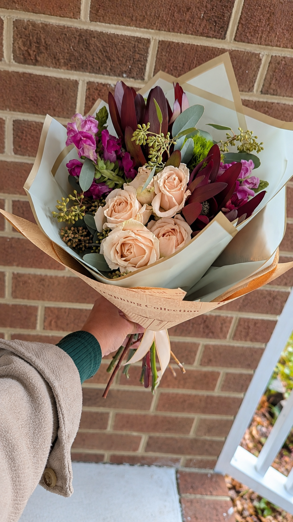 Hand-Held Blush Rose Bouquet on a Brick Porch.png