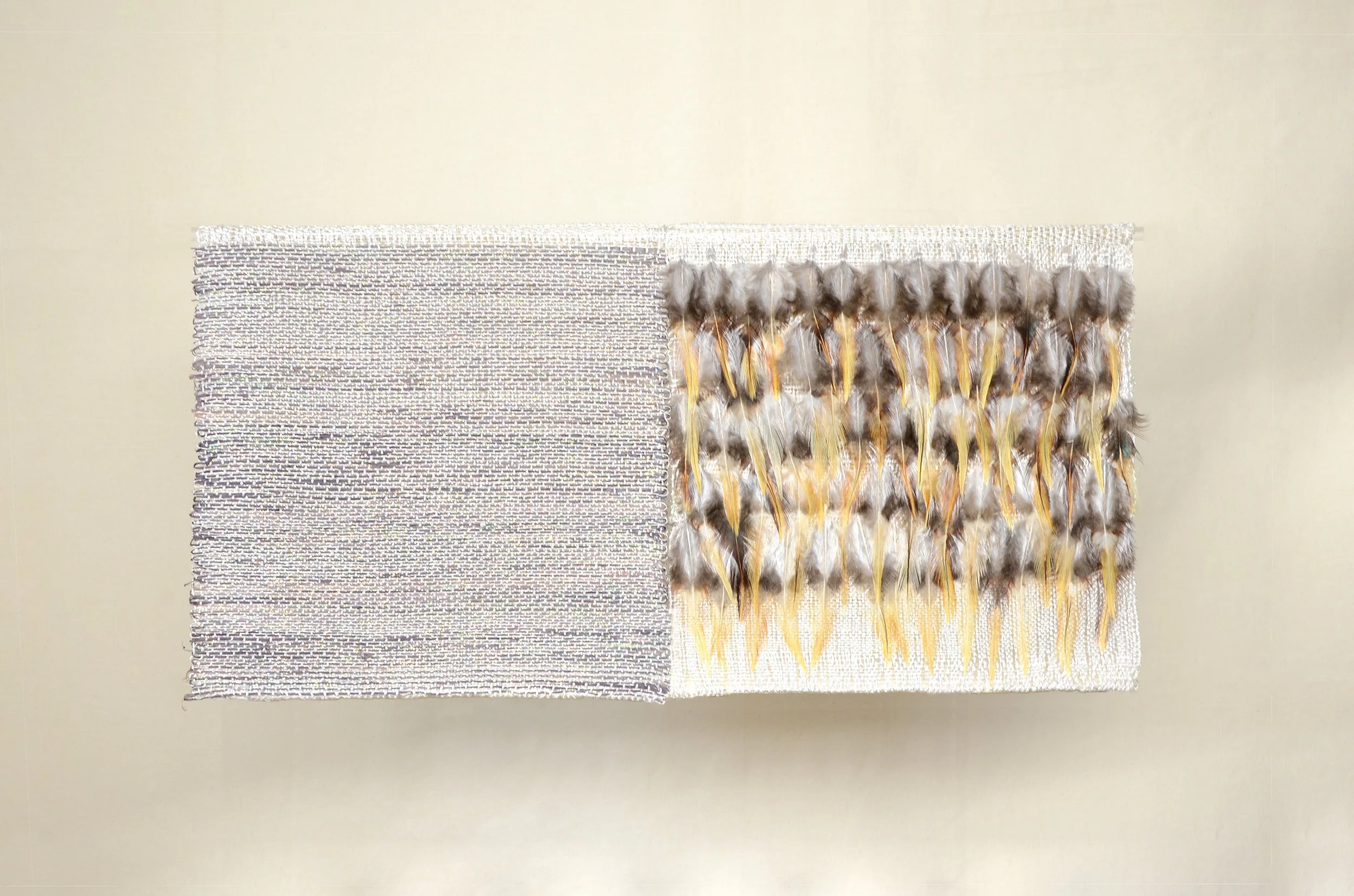 Luis Renteria // Mosaico II, 2026 // 
Feathers, rayon, polyester, copper thread, and raffia dyed with cochineal. Woven by hand on a pedal loom //  22 x 43 cm 