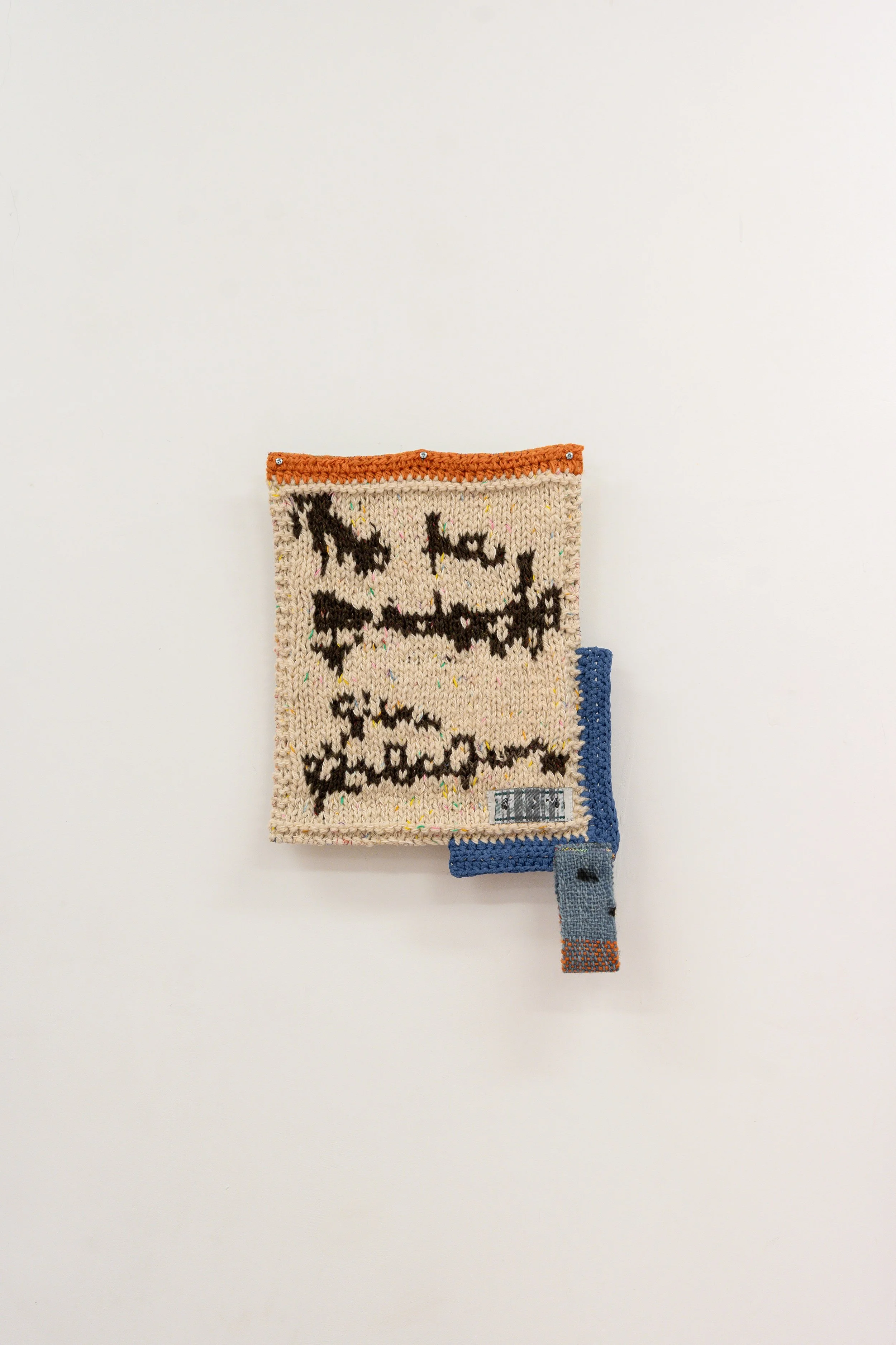 Me he quedado sin palabras, 2026 // Wool, burlap and steel eyelets (Knitting, loom weaving and crochet. Hand sewing) // 64 x 41 x 3 cm