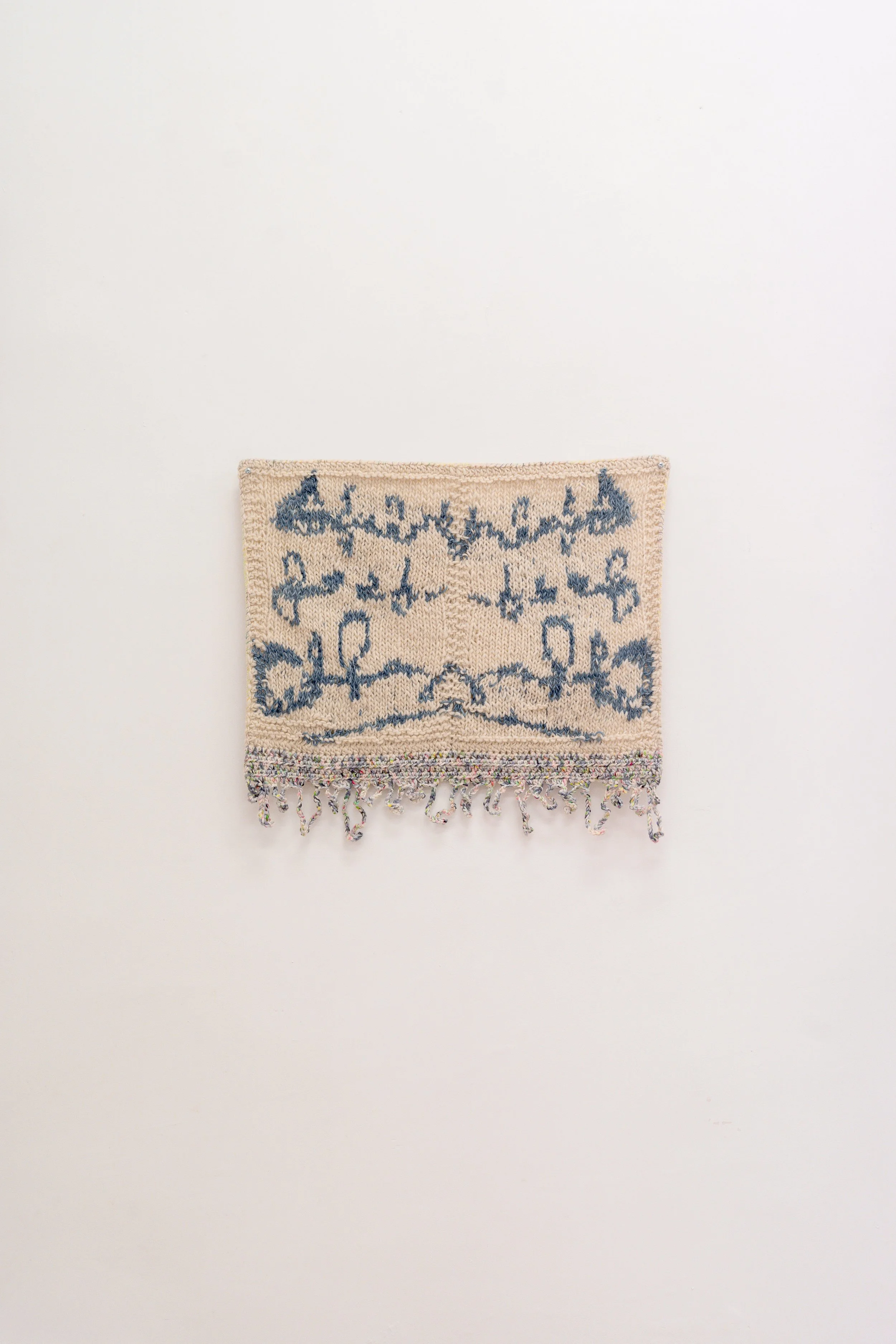 Nota en simetría, 2026 // Wool, burlap and steel eyelets (Knitting and crochet. Hand-sewn) // 52 x 62 x 3 cm