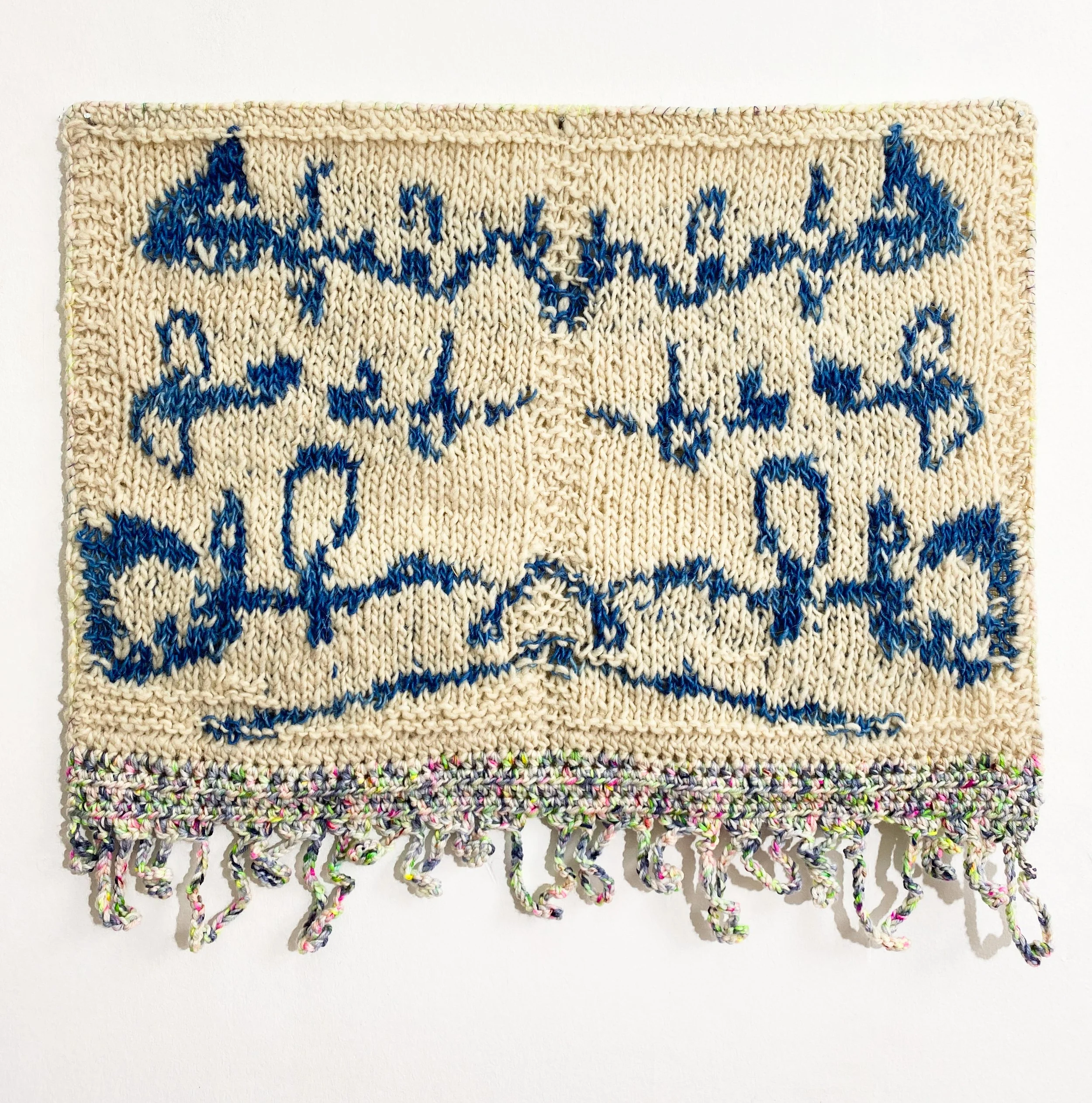 Nota en simetría, 2026 // Wool, canvas and steel eyelets (Knitting and crochet. Hand-sewn) // 52 x 62 x 3 cm