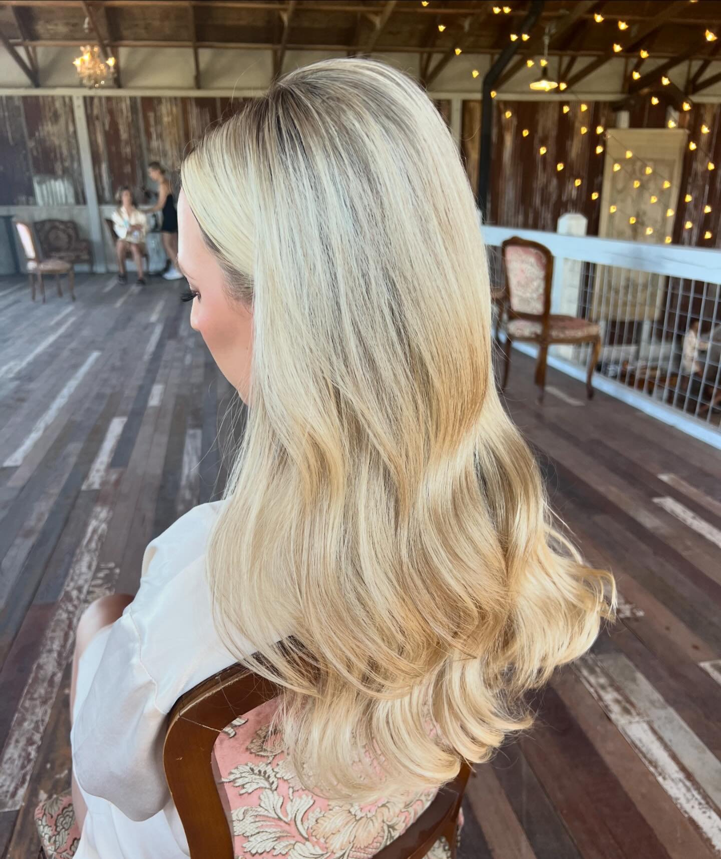 Curled down style with facial framing tucked behind the ears. Perfect for the modern bride who wants a soft bridal hairstyle that is effortless with fuller curls with a less structured curl but polished feel. Curls like this were achieved with a 1.25