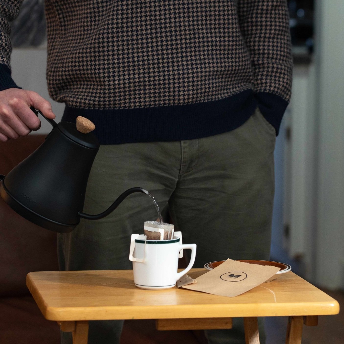Person standing behind a cup pouring into a MOJO.