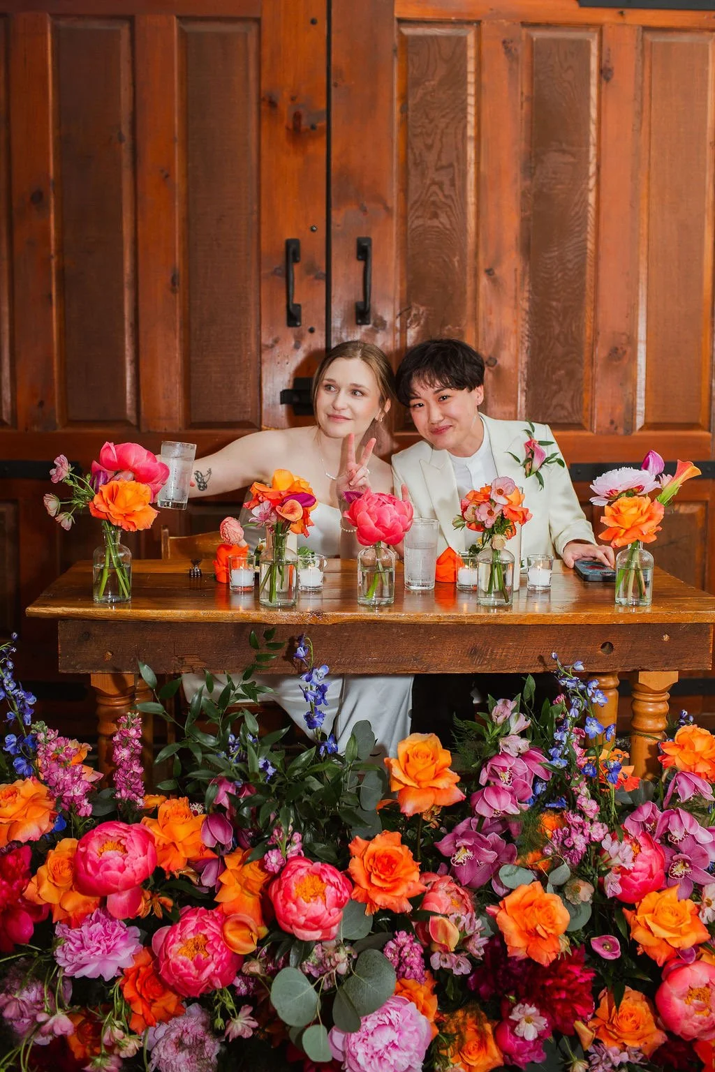 Alice and Stella at Chicago wedding table adorned with flowers 